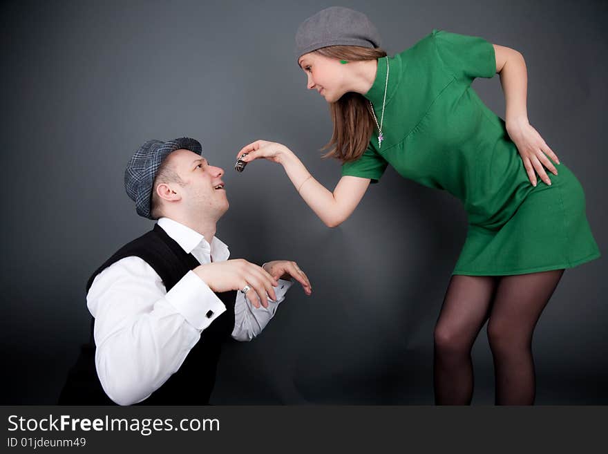 Pretty girl is nourishing big guy in a gray hat. Pretty girl is nourishing big guy in a gray hat