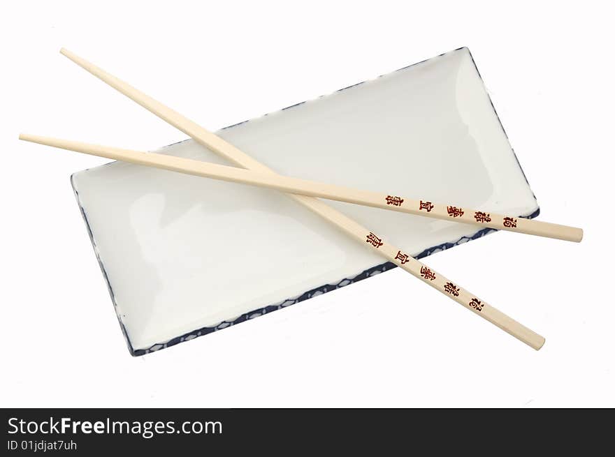 Wooden chop sticks on an empty plate. Wooden chop sticks on an empty plate