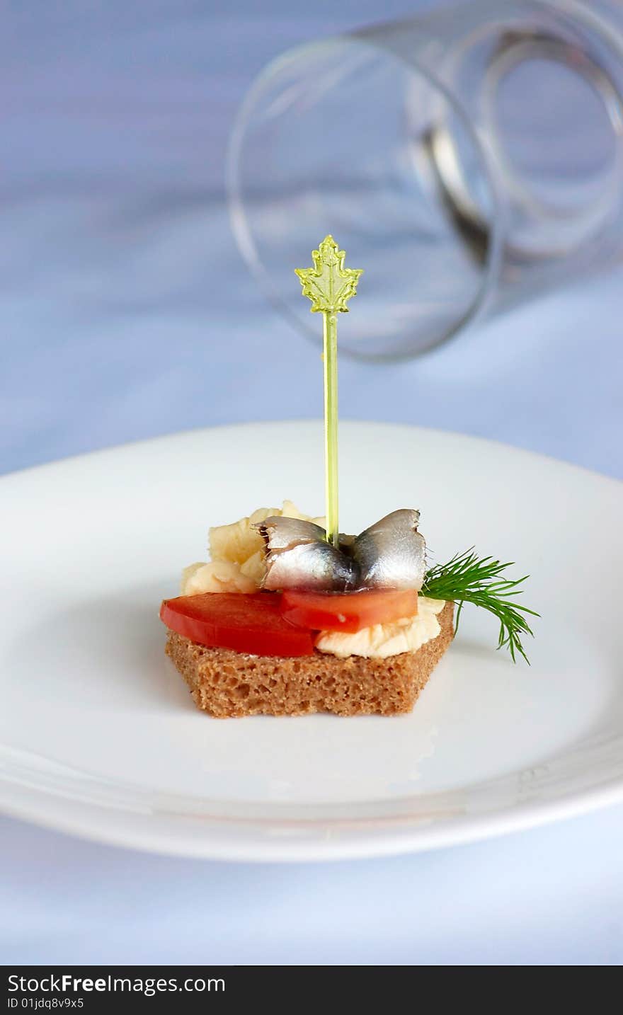 Table for a buffet. Canape with vegetables and herring