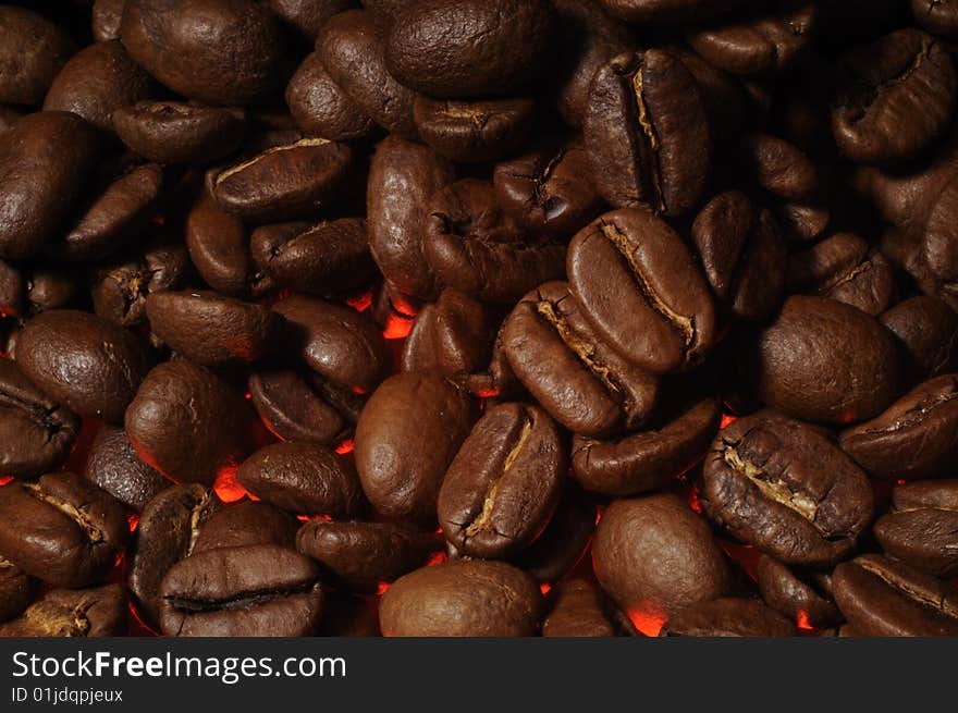 Closeup of coffee beans with red highlight. Closeup of coffee beans with red highlight