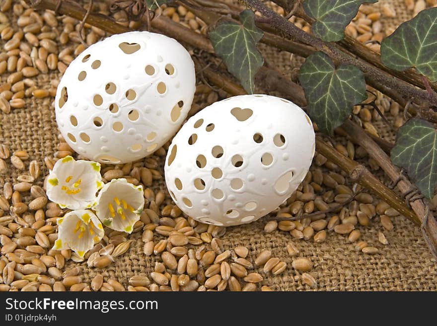 Easter egg against a background from jute and corn.