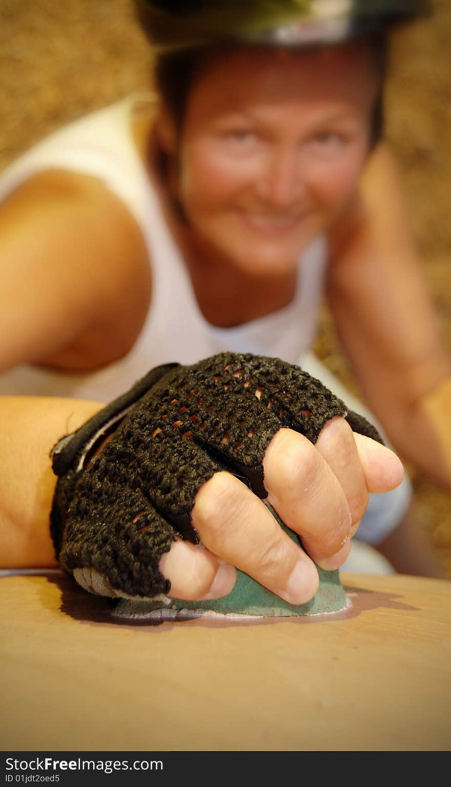 Senior woman working out on a rock climbing wall. Senior woman working out on a rock climbing wall