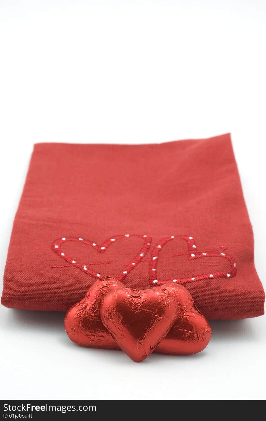 Red heart blanket with heart shaped chocolates. Red heart blanket with heart shaped chocolates