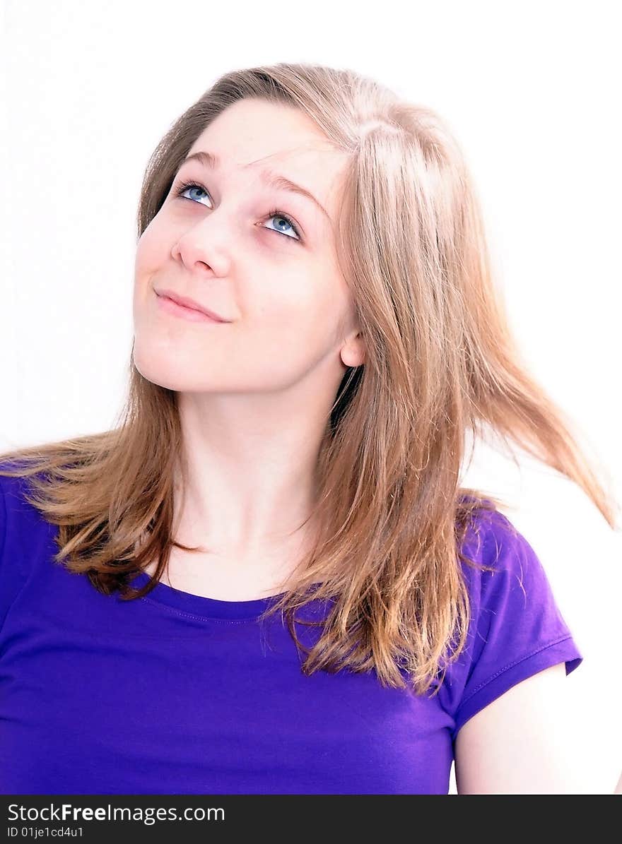 Studio Shot of a beautiful girl in a blue t-shirt dressing her hair, isolated on white background. Studio Shot of a beautiful girl in a blue t-shirt dressing her hair, isolated on white background