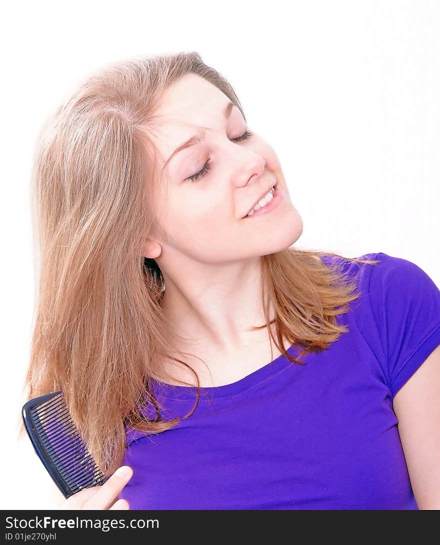 Studio Shot of a beautiful girl in a blue t-shirt dressing her hair, isolated on white background. Studio Shot of a beautiful girl in a blue t-shirt dressing her hair, isolated on white background