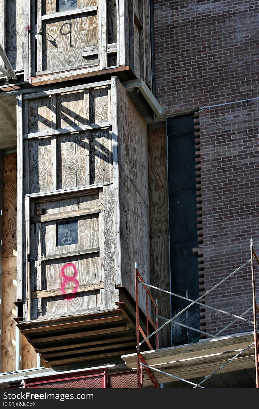 Construction Elevators Made of Wood Marked with the Numbers eight and nine on side of building