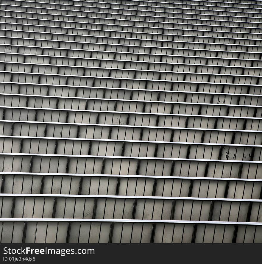 Tiers of Grey and Silver Grooved Metal Corrugation for Building Side