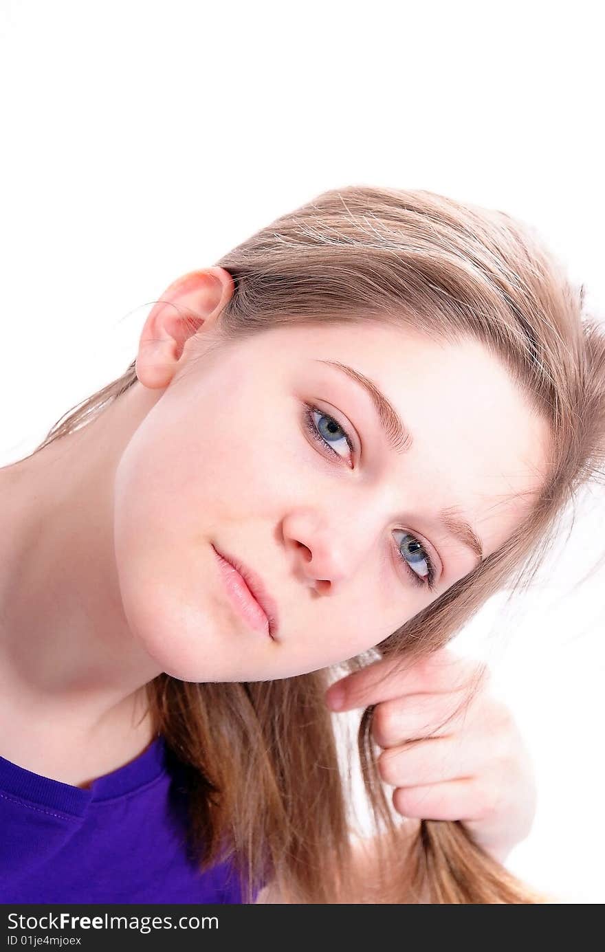 Studio Shot of a beautiful girl in a blue t-shirt dressing her hair, isolated on white background. Studio Shot of a beautiful girl in a blue t-shirt dressing her hair, isolated on white background