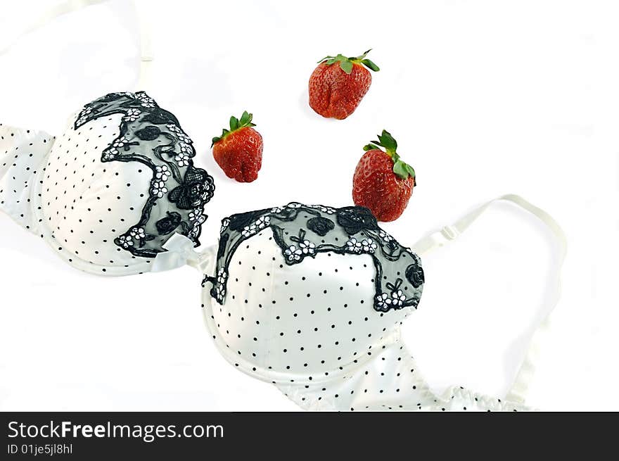 Silk bra and strawberry on white background with clipping path. Silk bra and strawberry on white background with clipping path.