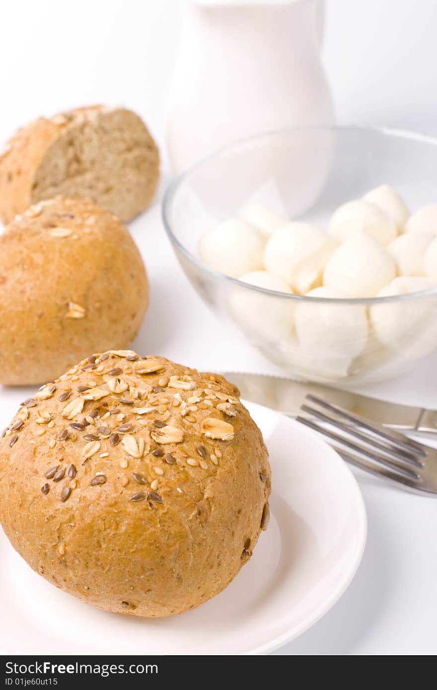 Bread, milk and mozzarella closeup on white