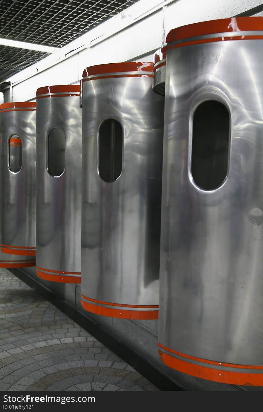 Orange and Silver Metal Public Phone Booths in Subway