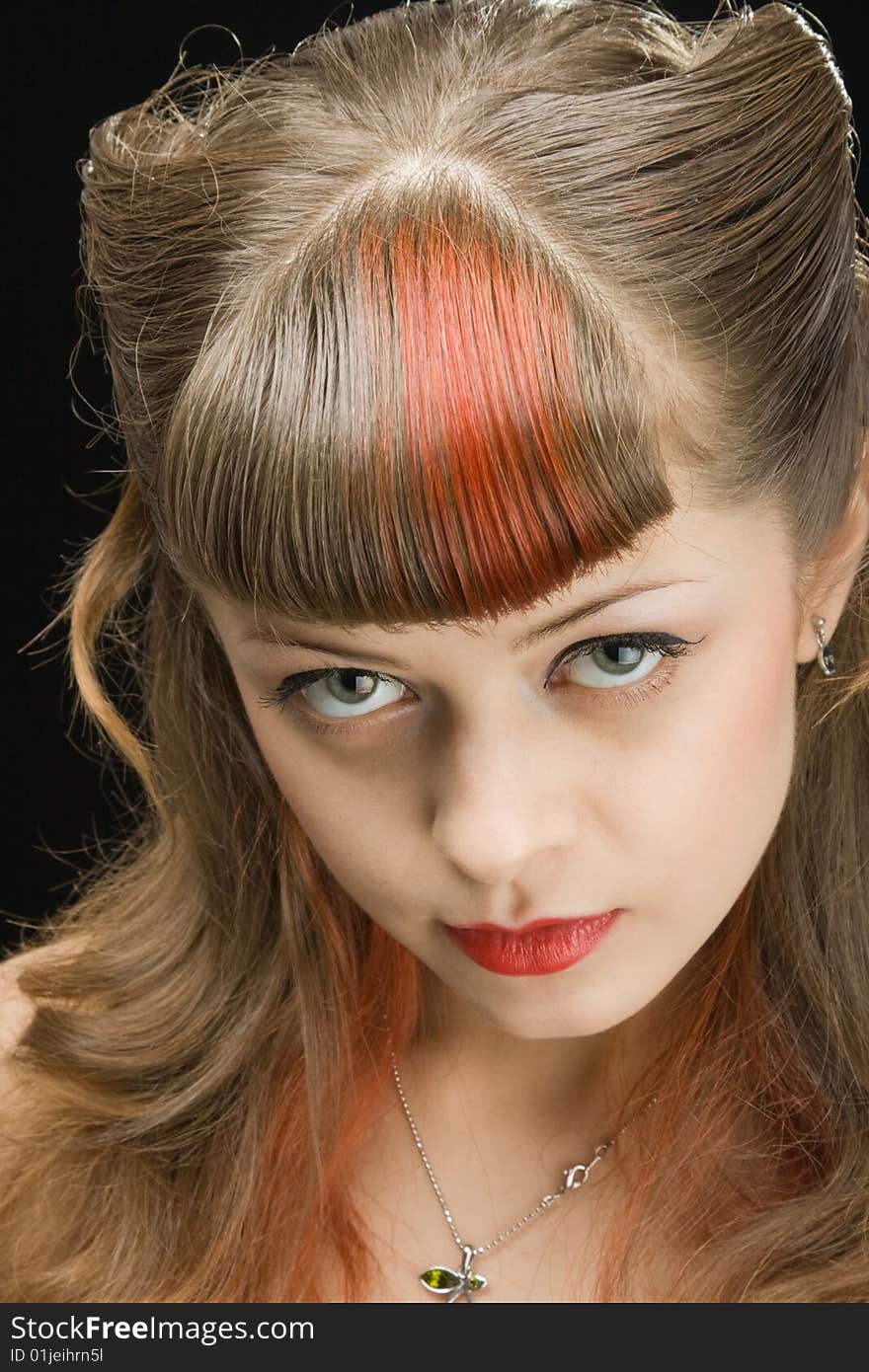 Pretty woman with light make-up looking seductively over dark background