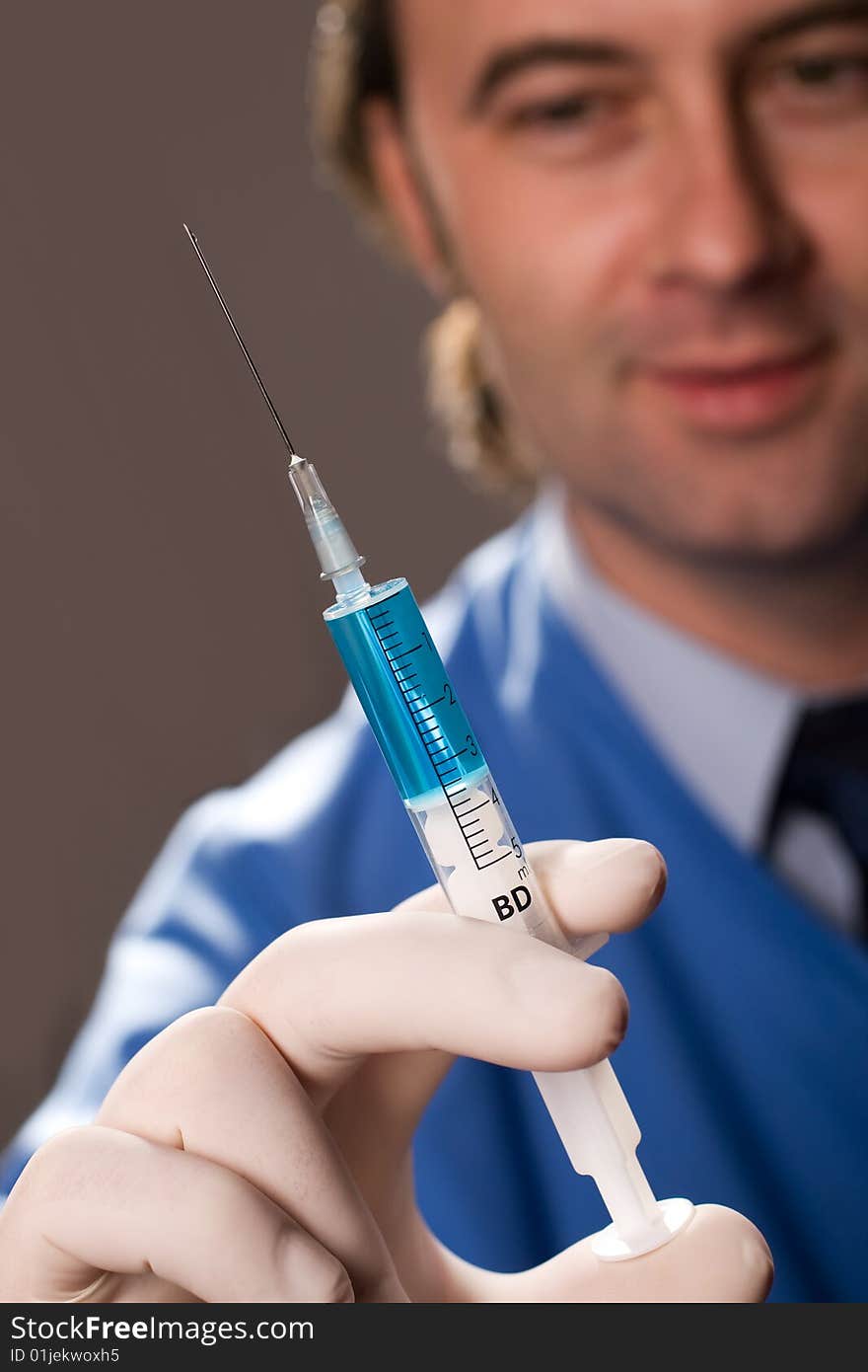 Male medic holding syringe. Isolated