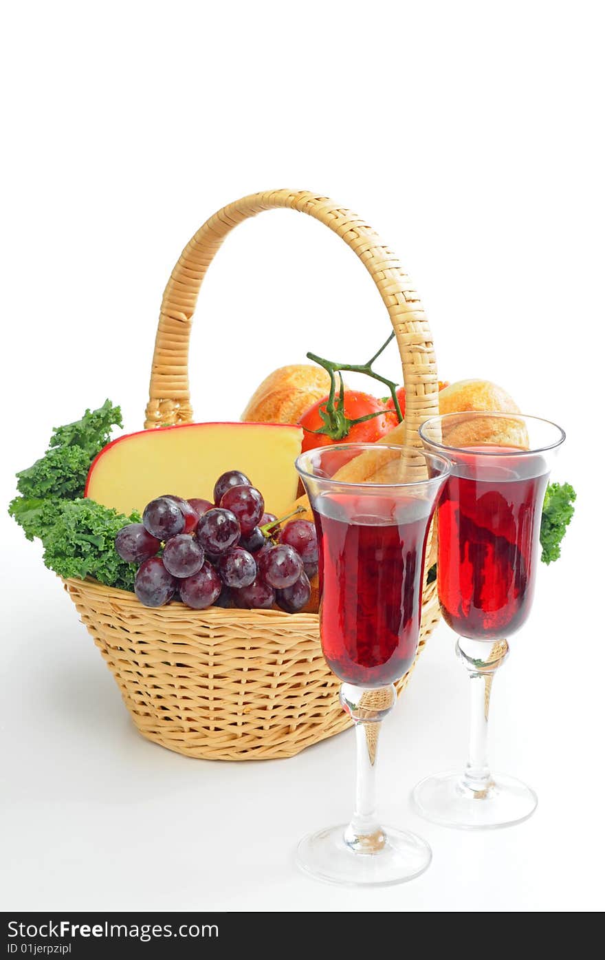 Red wine and a basket filled with bread and cheese. Red wine and a basket filled with bread and cheese.