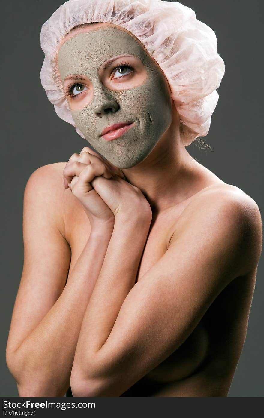 Young healthy woman with facial mask