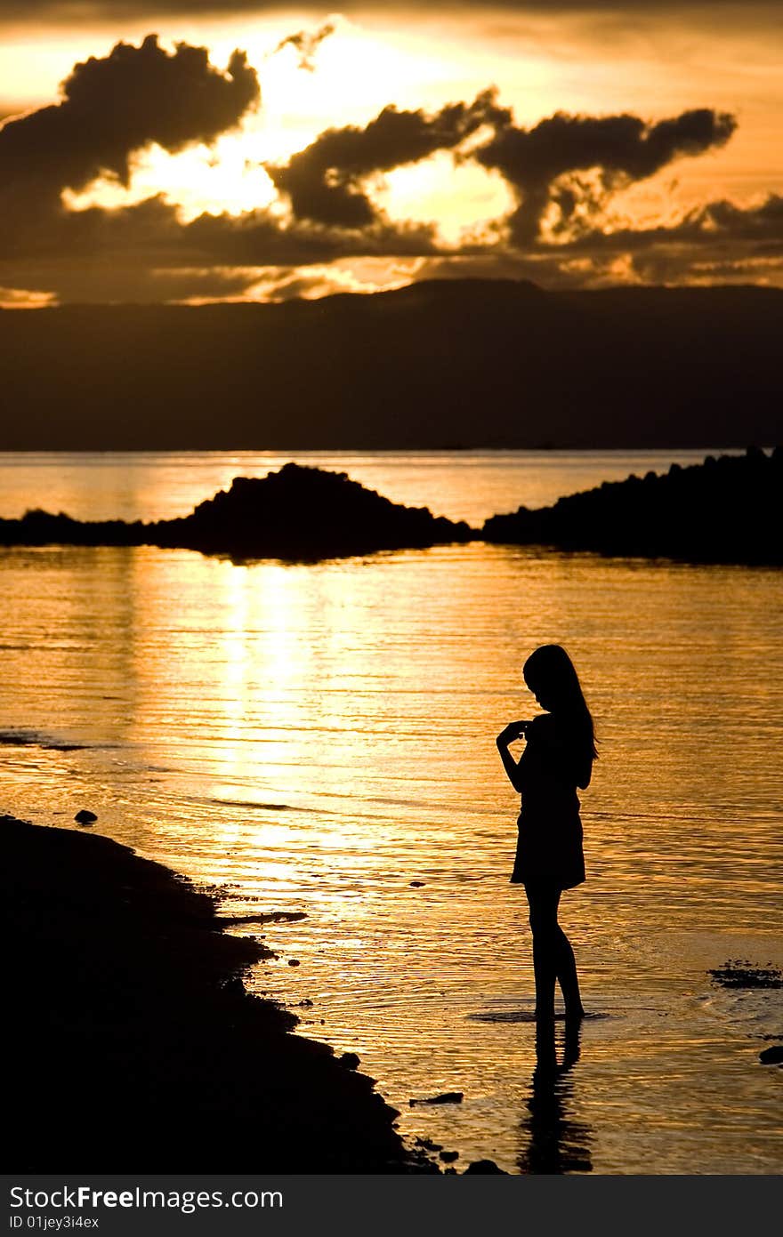 A girl stand in golden sunset