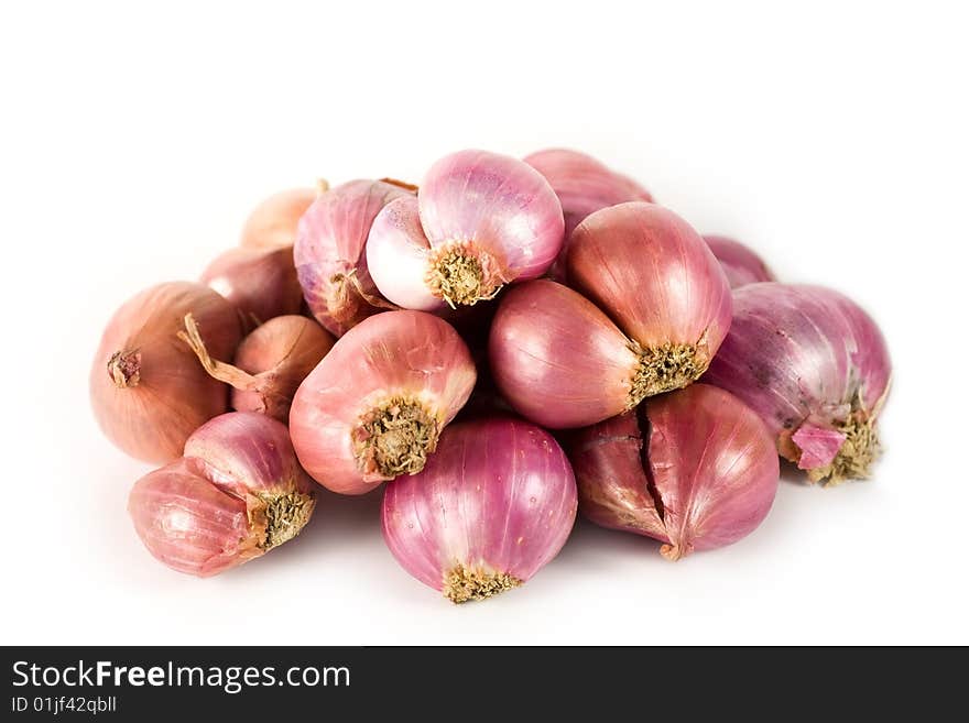 A heap of onions on white background