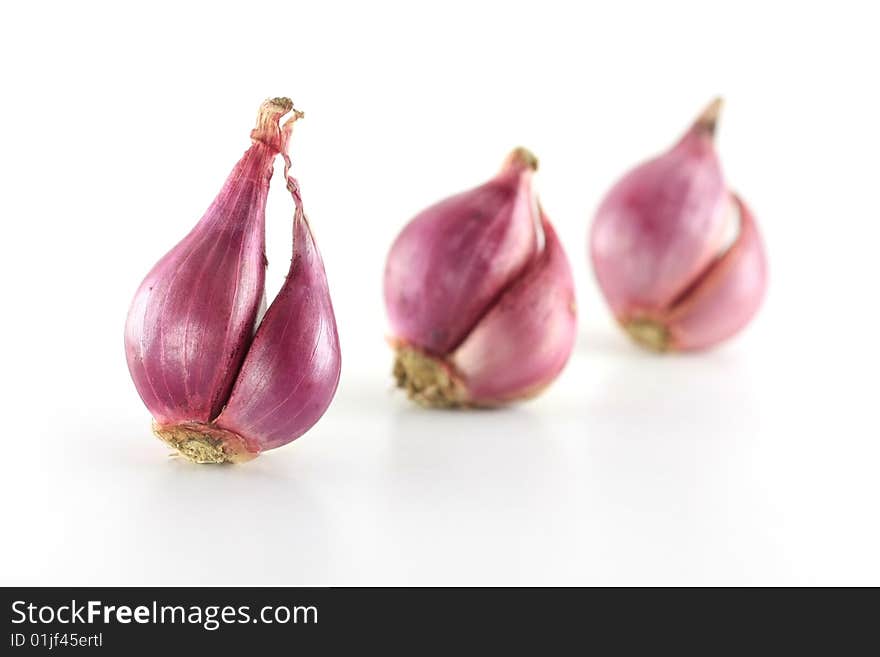 A row of 3 onions on white background