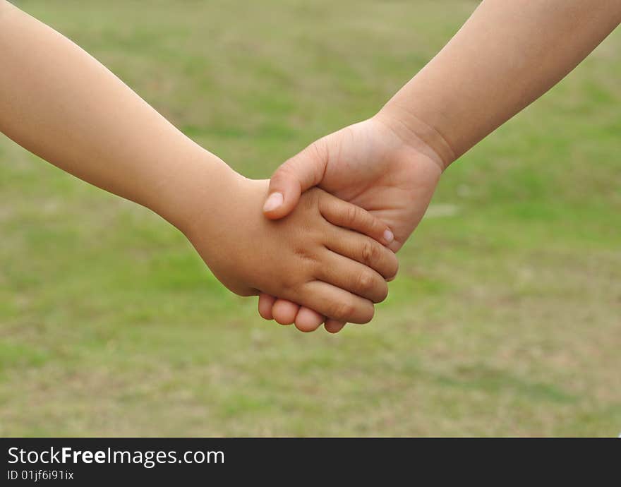 Childrens hand in hand close-ups