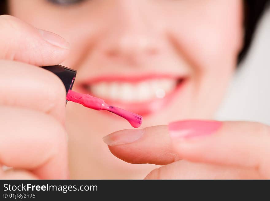 Woman applying red nail polish