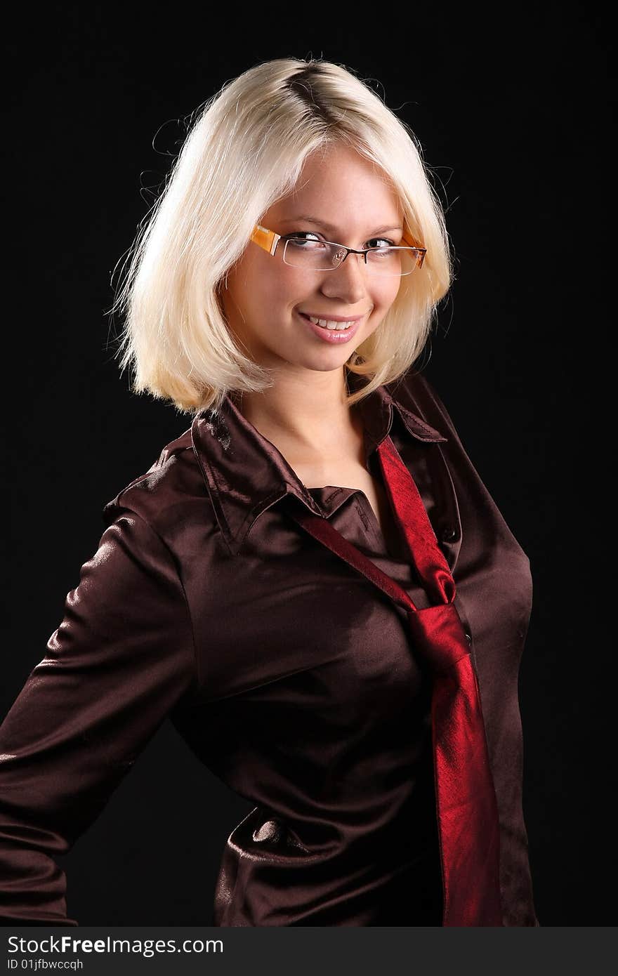 Beautiful lady with necktie and glasses on a black background