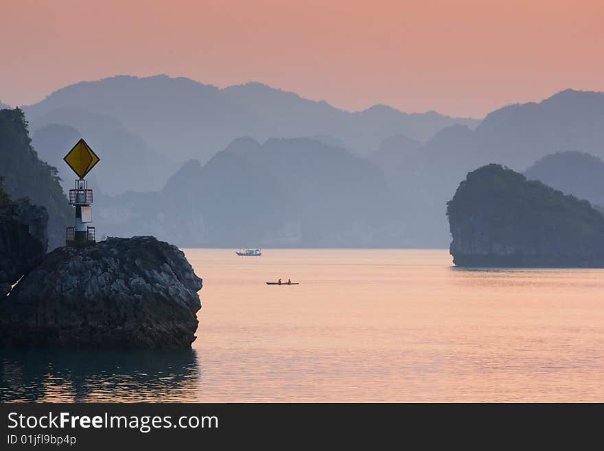 Leading light, boat and islands in Ha Long Bay, Northern Vietnam