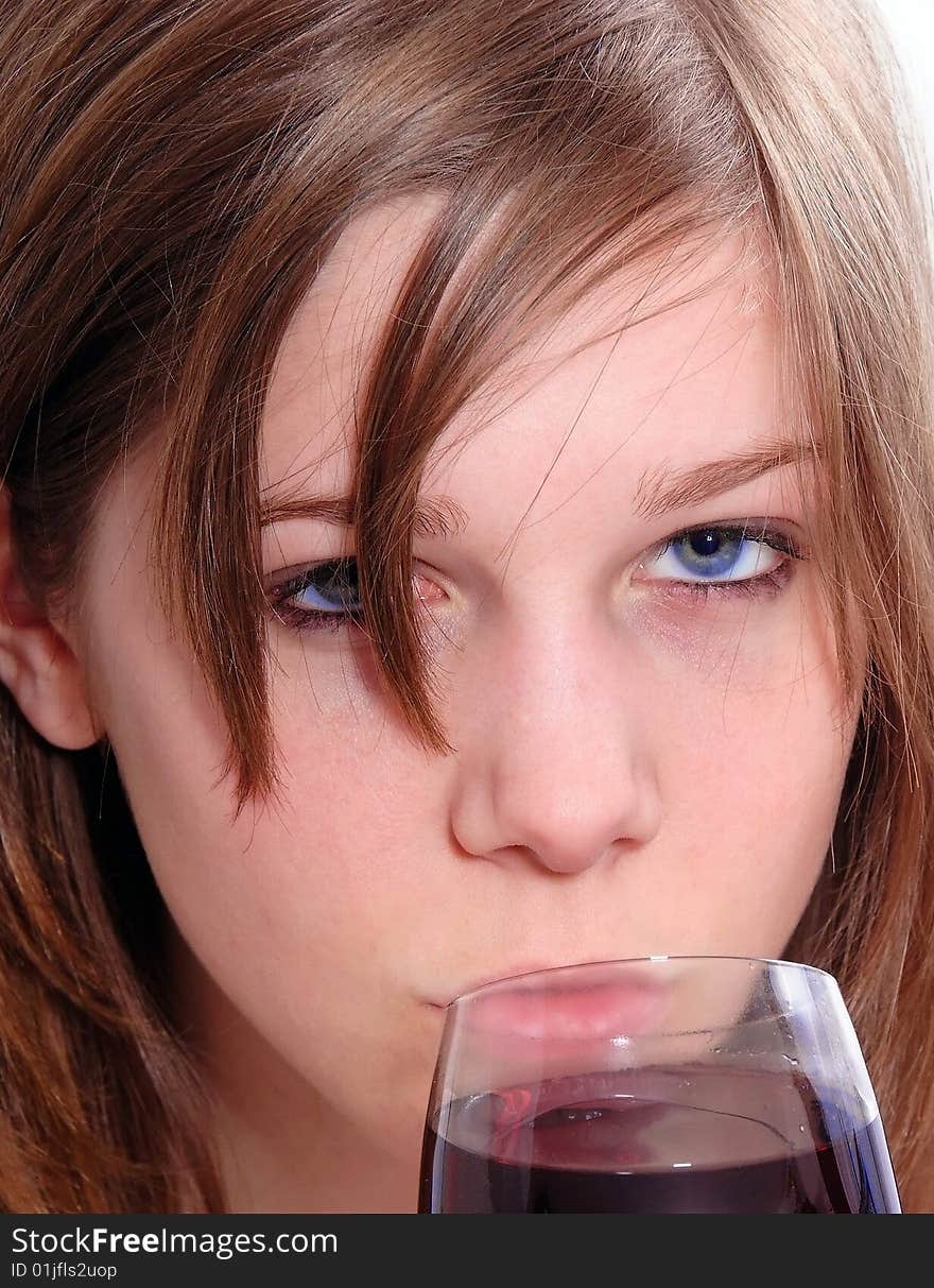 Brunette Woman in a purple shirt drinking red wine, isolated on white background. Brunette Woman in a purple shirt drinking red wine, isolated on white background