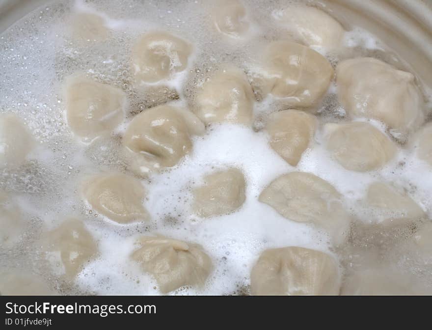 Russian ravioli (pelmeni) boiling in pot. Russian ravioli (pelmeni) boiling in pot