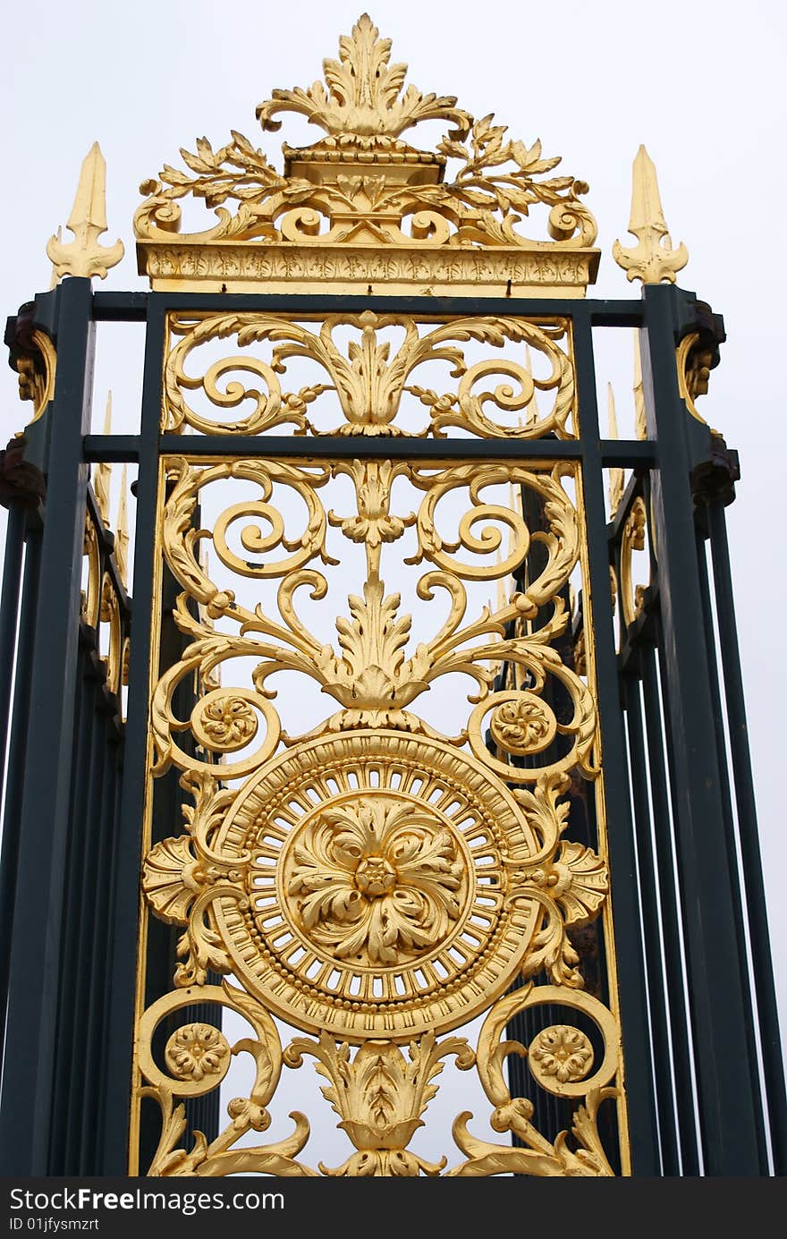 Golden metallic decoration of a gate at Louvre palace. Golden metallic decoration of a gate at Louvre palace