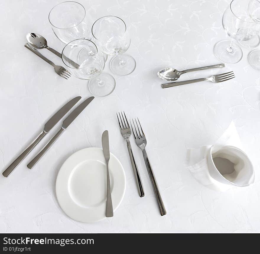 Knife, fork, spoon, plate and glases on a table. Knife, fork, spoon, plate and glases on a table