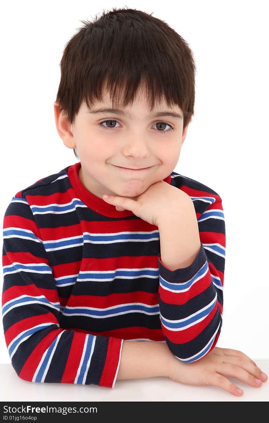 Adorable five year old boy making bored grin expression.  Face resting on hand.