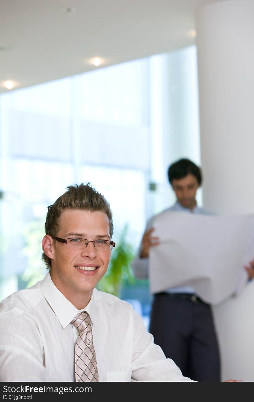 Confident young business man looking at camera.