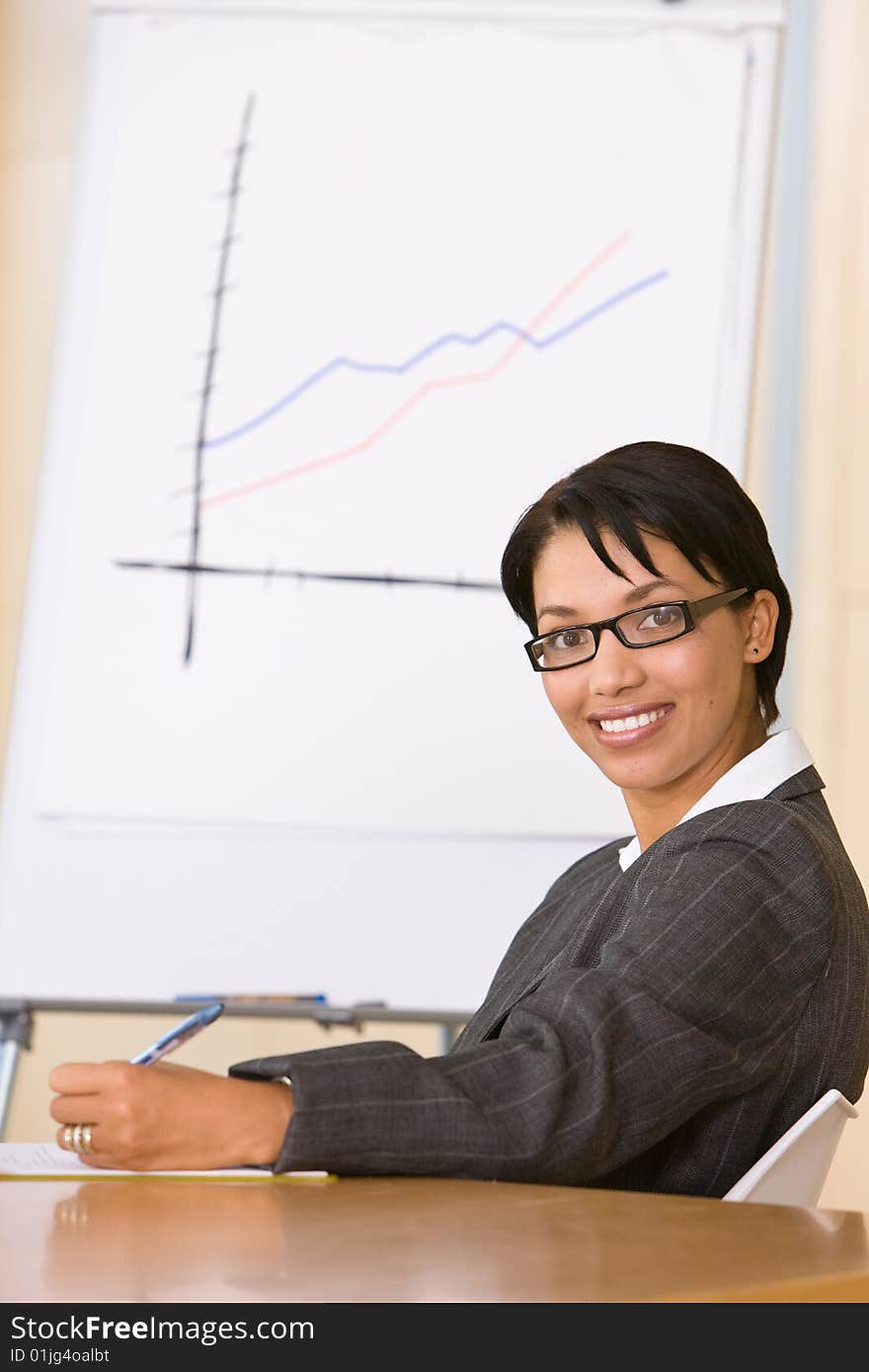 Smiling portrait of business woman in the board room. Smiling portrait of business woman in the board room