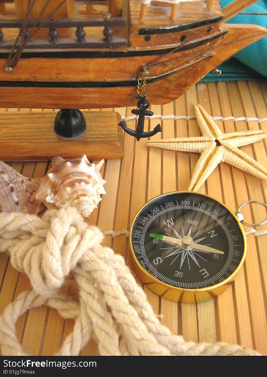 Sea still life. Compass, rope and seashells