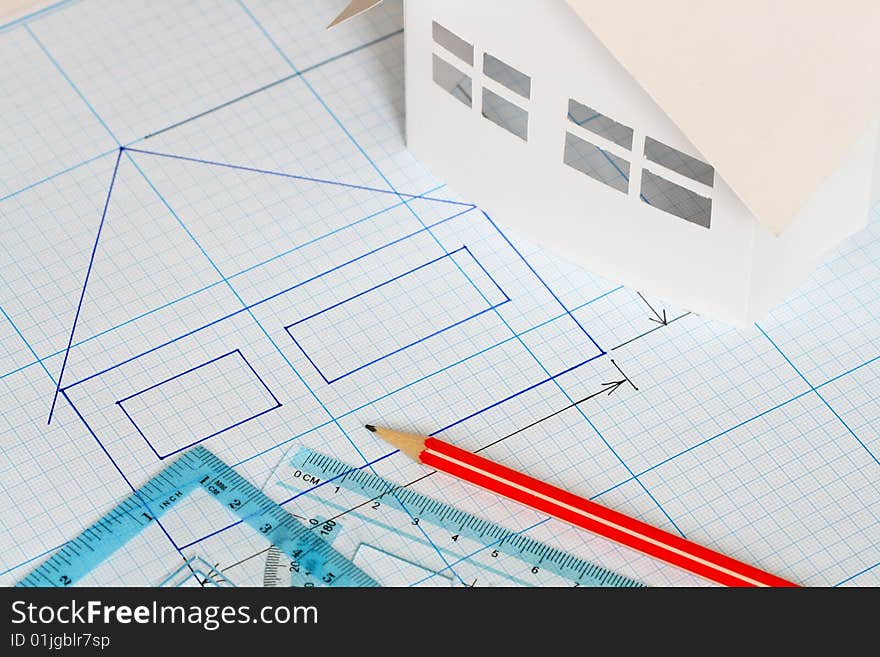 Drawing tools and little house on graph paper background. Drawing tools and little house on graph paper background