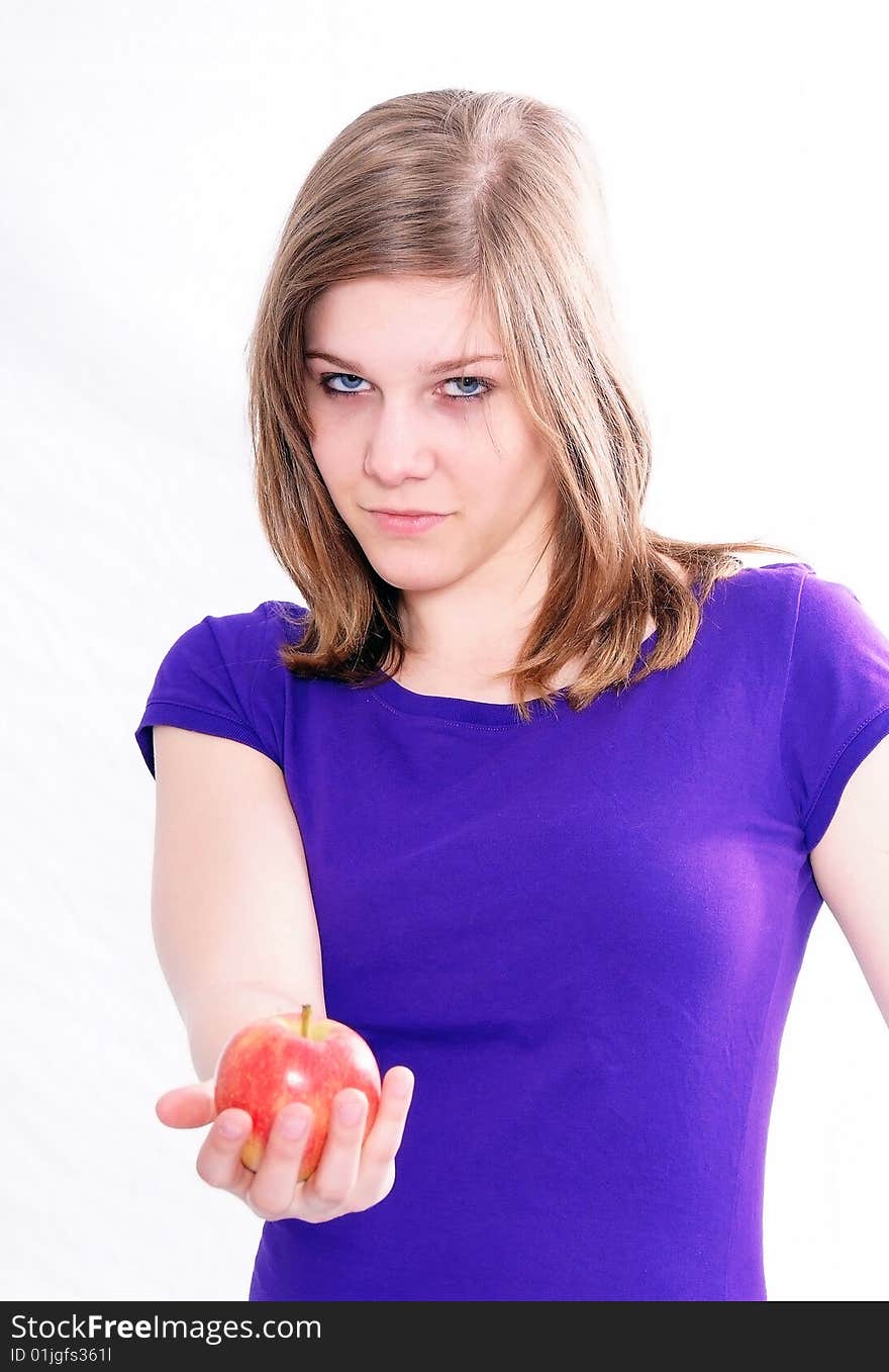 A studio shot of a beautiful girl holding an apple in her hand, isolated on white background. A studio shot of a beautiful girl holding an apple in her hand, isolated on white background