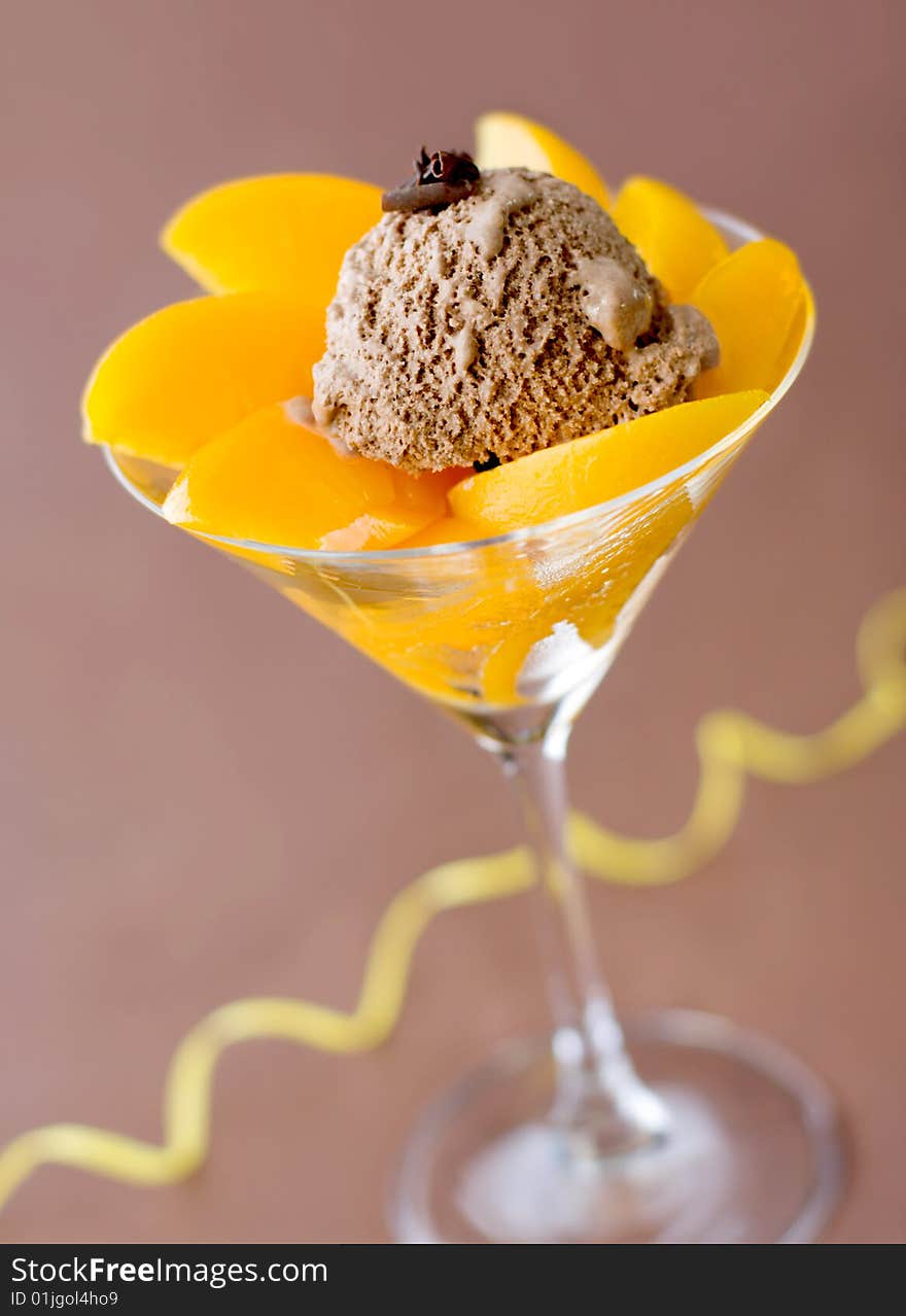 Close-up of a glass filled with peaches and ice-cream. Close-up of a glass filled with peaches and ice-cream