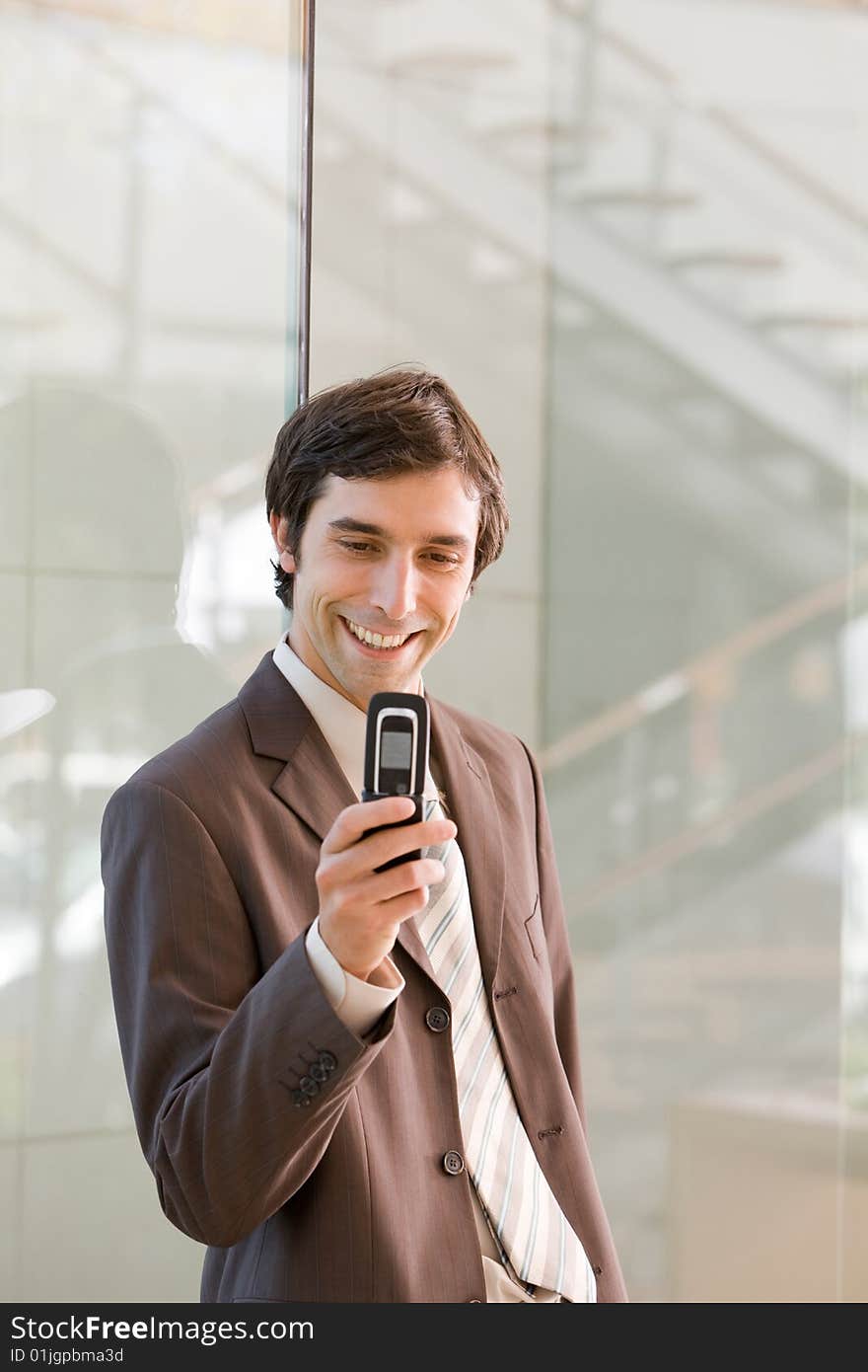 Portrait of confident smiling business man holding cell phone. Portrait of confident smiling business man holding cell phone.