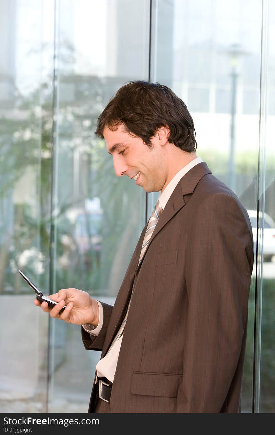 Portrait of confident smiling business man holding cell phone. Portrait of confident smiling business man holding cell phone.