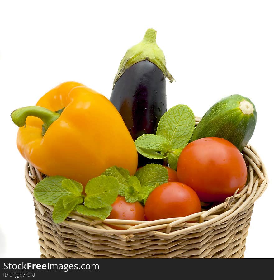 Basket with pepper, eggplant and tomatoes isolated on a white background. Basket with pepper, eggplant and tomatoes isolated on a white background