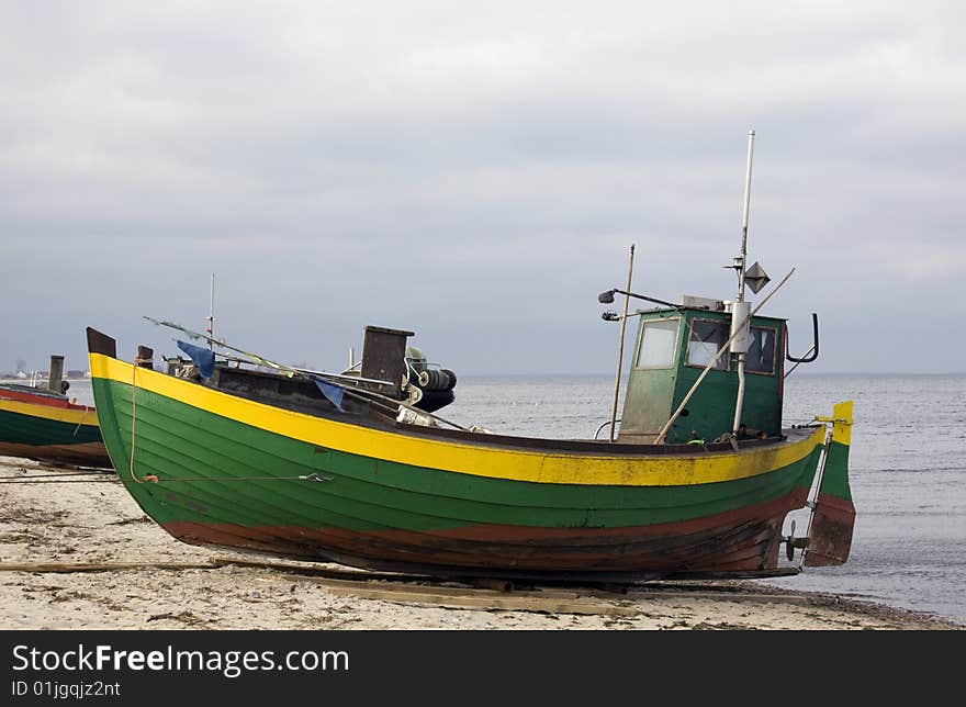 Green fisher boat on the seashore