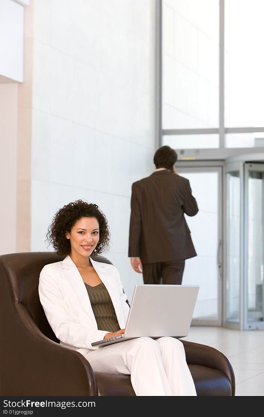 Attractive business woman working on laptop.