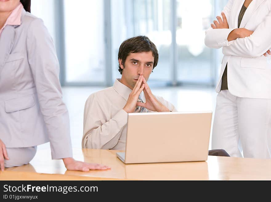 Confident business man working on laptop.