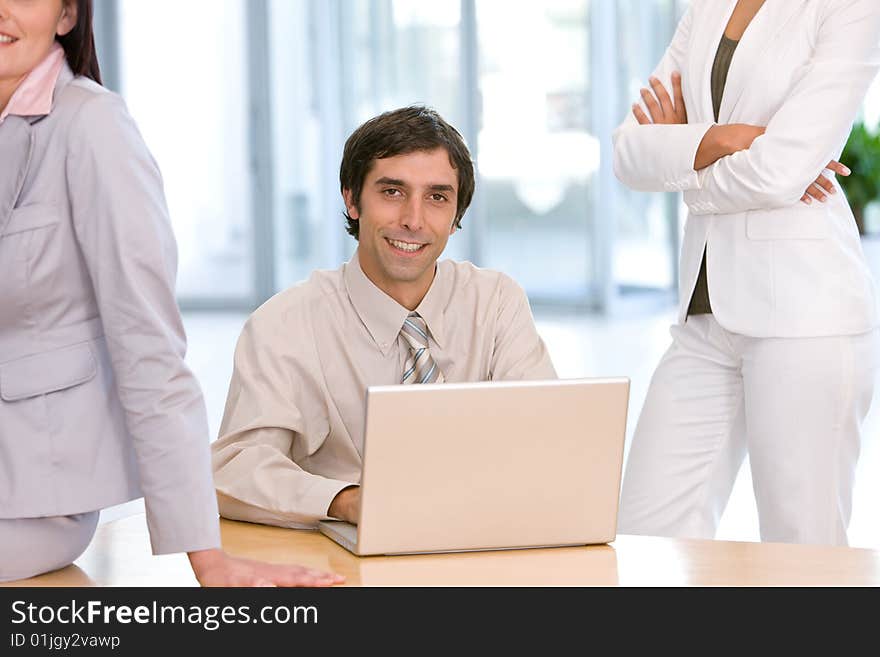 Confident business man working on laptop.