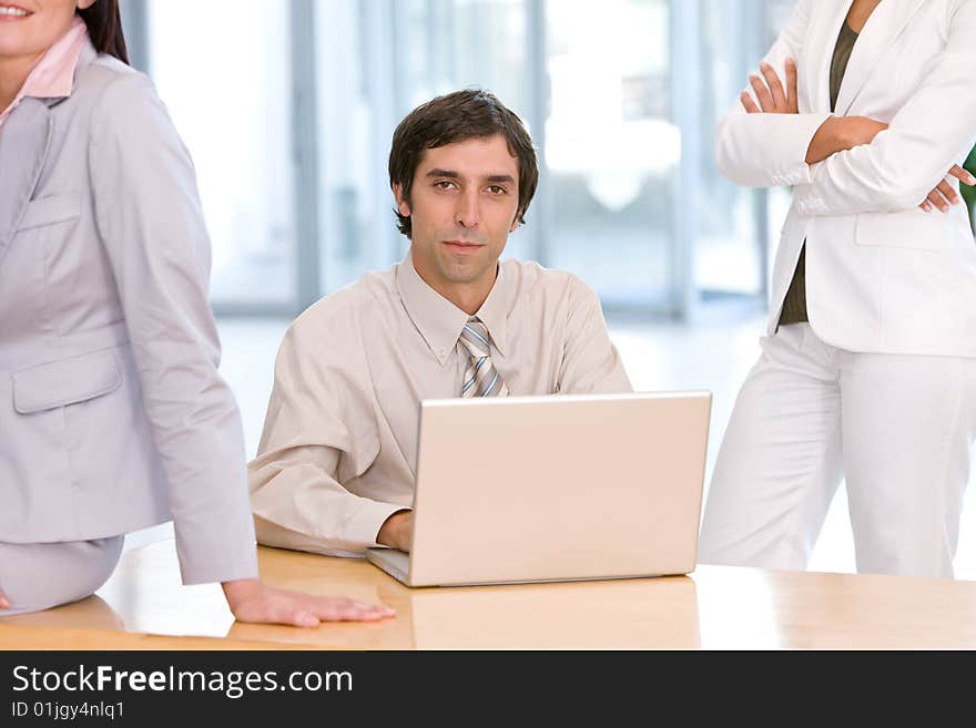 Confident business man working on laptop.