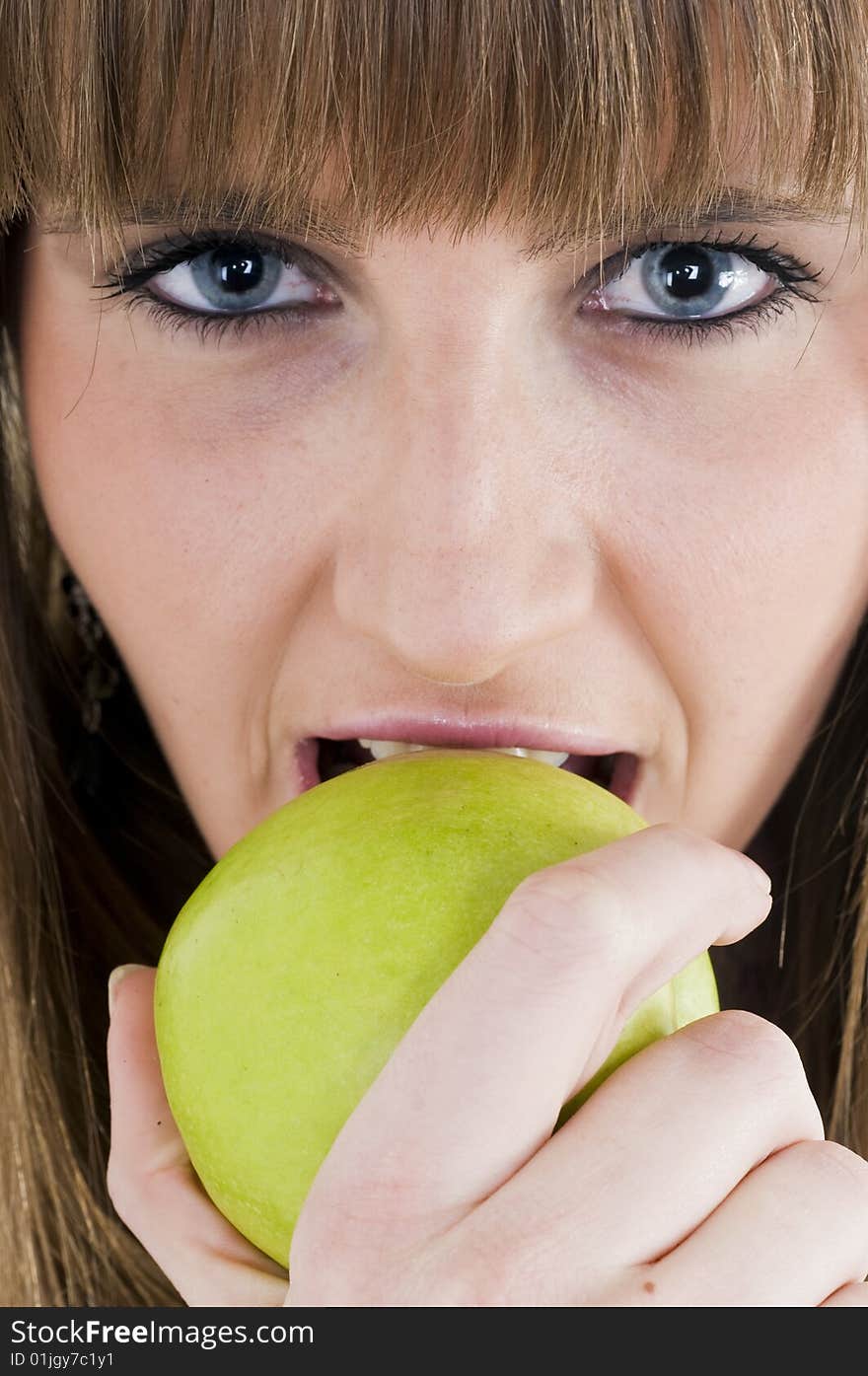 Young blue eyes girl with green apple. Young blue eyes girl with green apple.