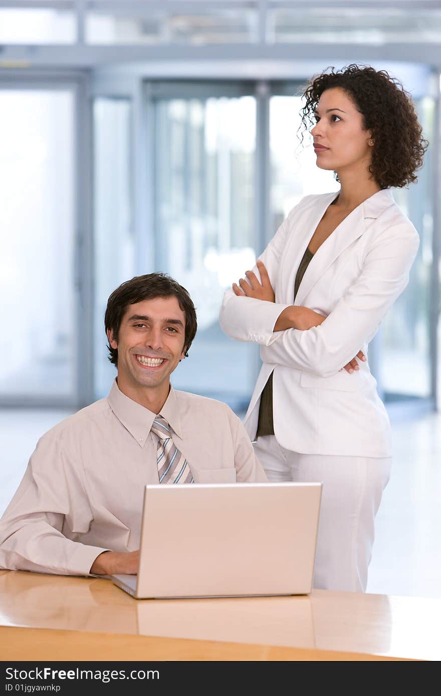 Business meeting with business man busy on laptop.