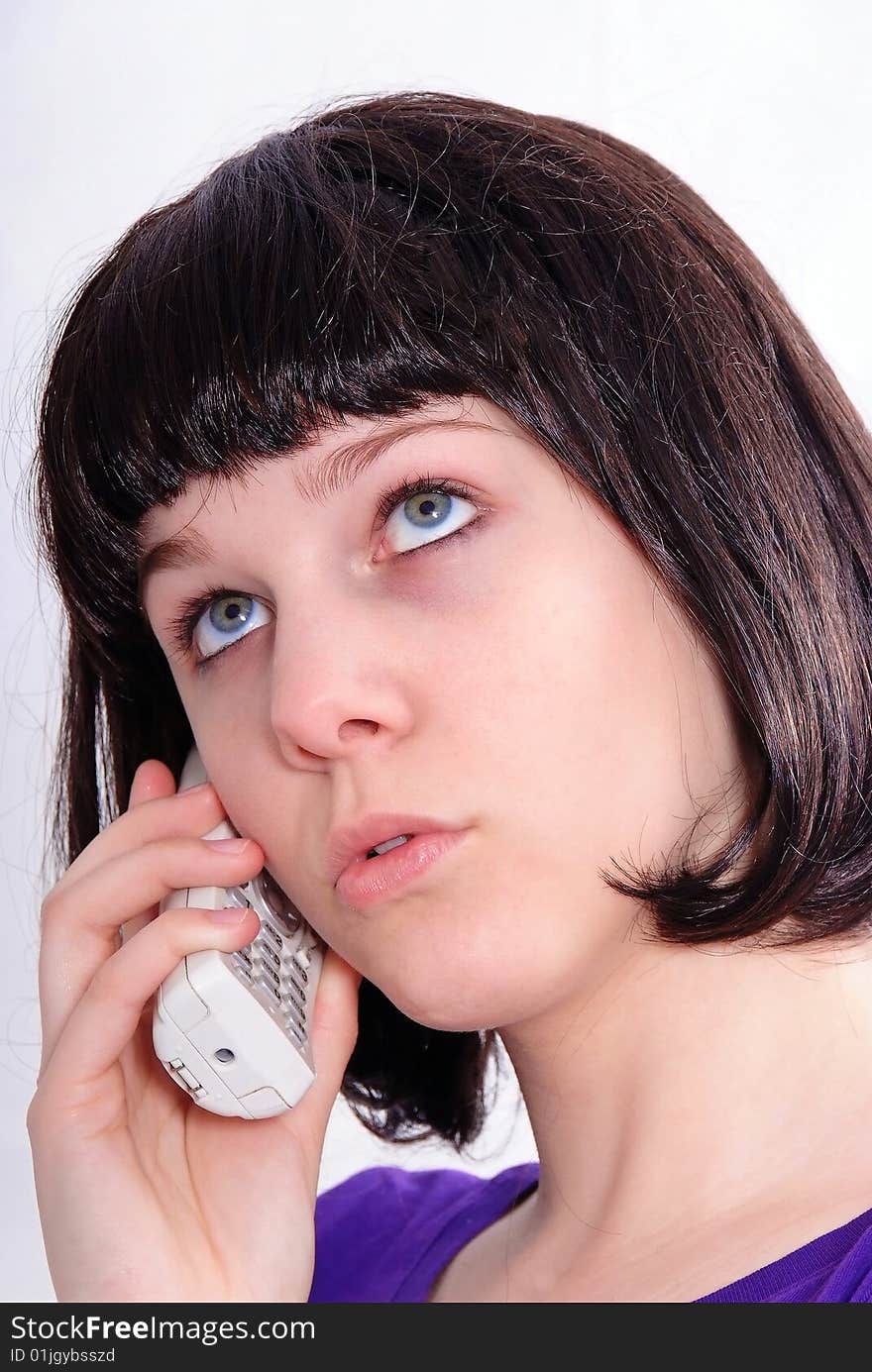 Studio shot of a beautiful brunette woman communicating on the telephone. Studio shot of a beautiful brunette woman communicating on the telephone