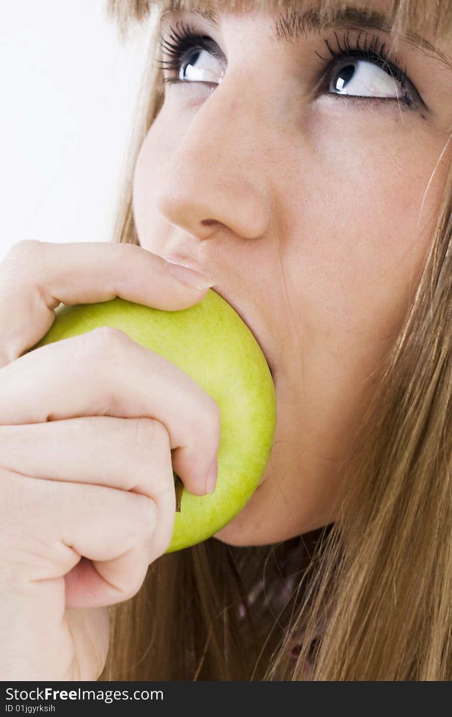 Young blue eyes girl with green apple. Young blue eyes girl with green apple.