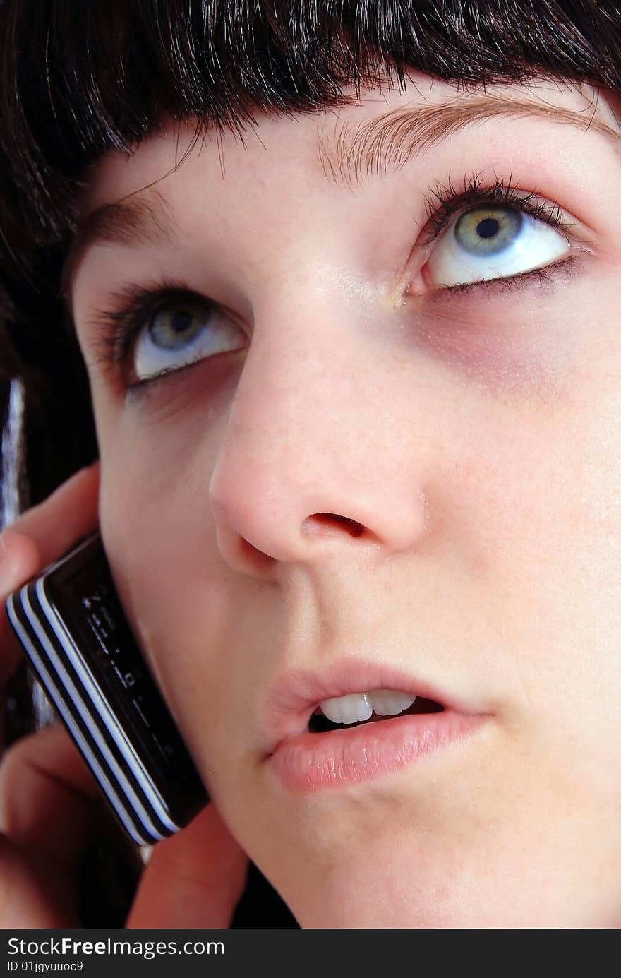 Studio shot of a beautiful brunette woman communicating on the telephone. Studio shot of a beautiful brunette woman communicating on the telephone